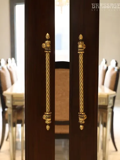 This image captures the intricate, twisted design of the Chelsea pulls, highlighting the craftsmanship and the warm glow of the Antique Gold finish.