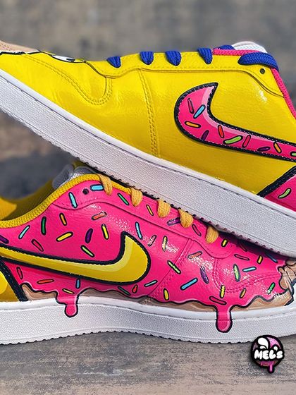 A detailed close-up of the dripping donut effect on both the Homer and the pink donut shoe, showing the glossy finish on the hand-painted sprinkles.