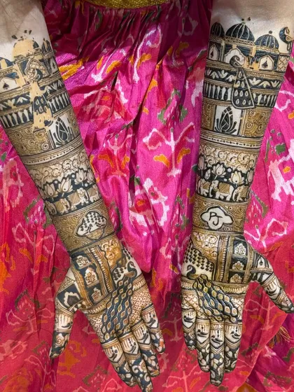 A complex and beautiful bridal design featuring palace architecture, elephants, and the couple's initials 'P' and 'J'. This is a perfect example of a royal-themed mehendi.