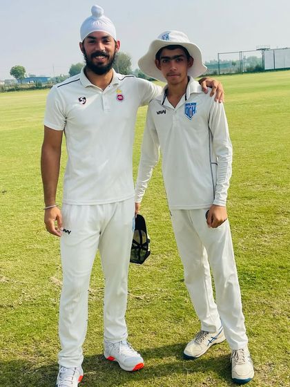 Shubham Shokeen with a senior player after his impressive leg-spin performance on debut.