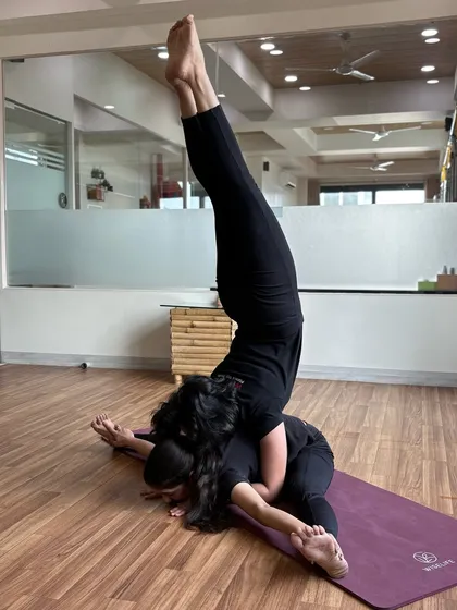 Explore connection and trust through our couple yoga sessions. This advanced acro-yoga pose showcases the balance and strength that can be achieved when two souls flow together as one.