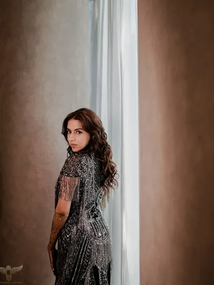 A dramatic and alluring portrait of the bride-to-be looking over her shoulder. The soft lighting and her compelling gaze create a captivating and timeless image.