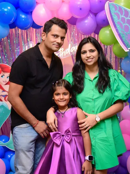 Magical moments with the family. A lovely portrait in front of the mermaid-themed party decor.