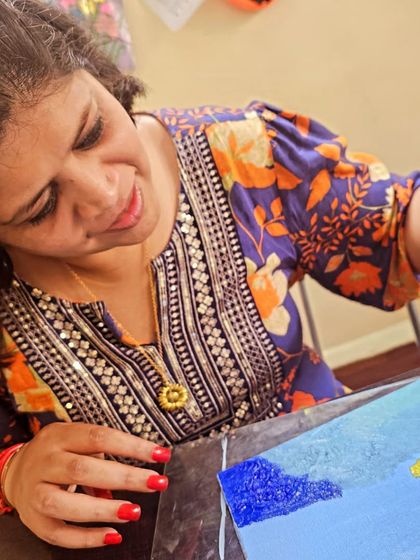 The artist at work. A close-up of a student fully engaged in the creative process during our palette knife painting workshop.