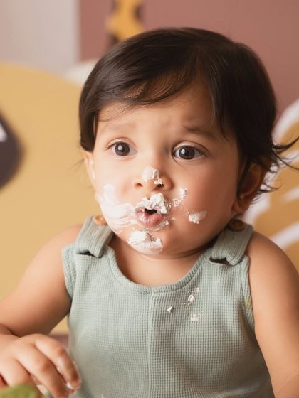 The aftermath of the cake smash. Frosting on the nose and a look of pure satisfaction. These are the memories that will always make you smile.