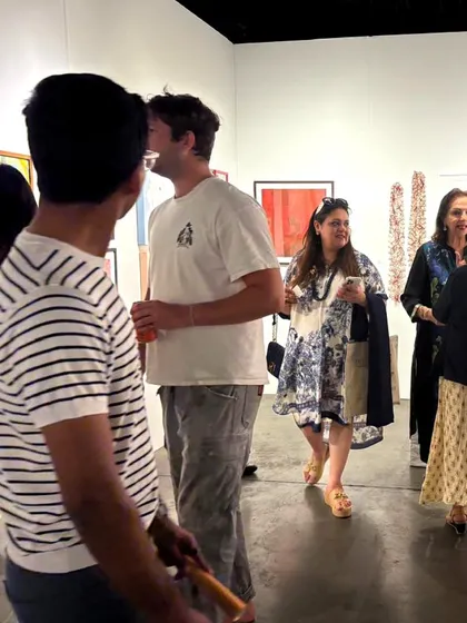 Guests mingling and discussing art inside our booth during the Seattle Art Fair opening.