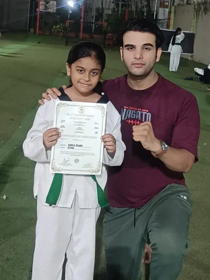 I'm honored to present this green belt certificate to a deserving student. Her progress has been outstanding.