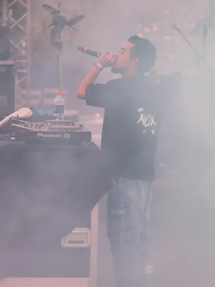 A candid shot from JLN Stadium, surrounded by stage smoke. I perform in all conditions, focused on delivering a powerful set of hip hop, DHH, and commercial tracks.