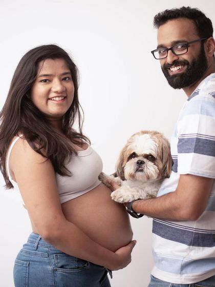 Fur babies are family too. This adorable portrait includes the couple's beloved dog, making it a complete and heartwarming family photo.