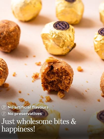 A Panjiri Laddoo broken in half to show its rich, nutty texture. The text highlights my promise: "No artificial flavours, No preservatives."