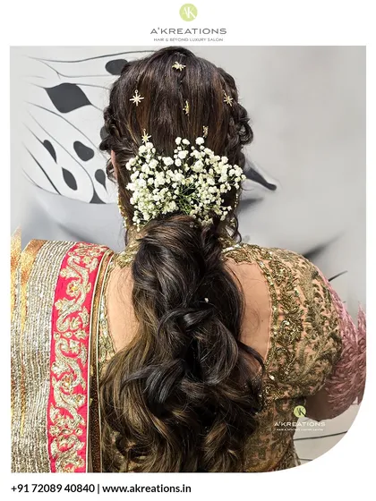 We crafted this elegant hairstyle for a traditional event. The look features intricate braids leading into a voluminous, curled ponytail, adorned with delicate baby's breath flowers for a touch of timeless beauty.