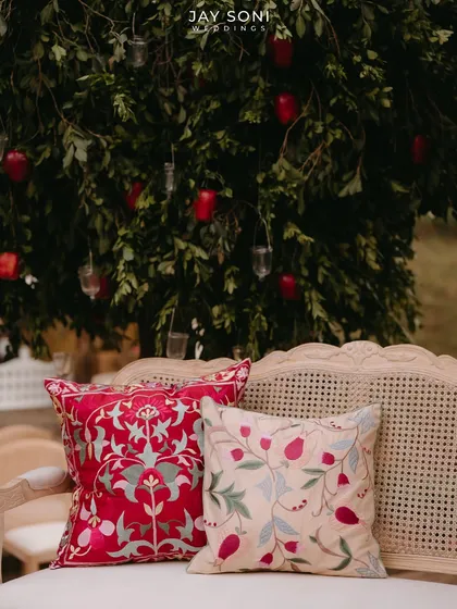 A close-up of the beautifully embroidered cushions used in the lounge seating, adding color and texture to the decor.