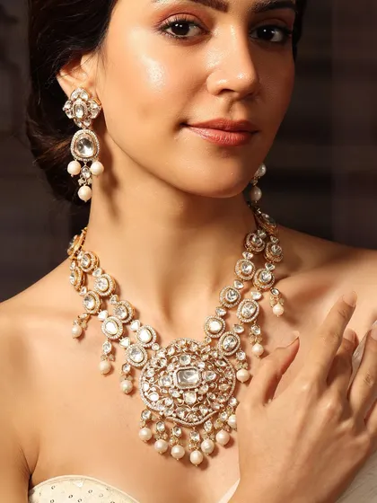 A magnificent polki and pearl necklace set, designed with a large central pendant to create a look of pure opulence.