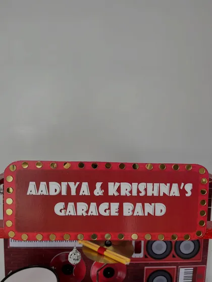 The personalized marquee sign for 'Aadiya & Krishna's Garage Band' makes this gift their very own stage for imaginative play.
