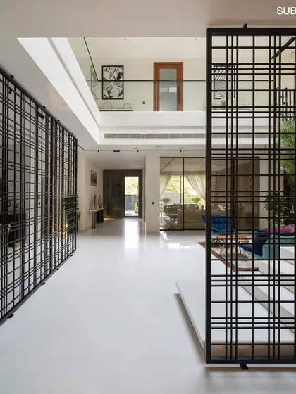 These symmetrical partitions act as both functional dividers and decorative screens, adding visual interest and a sense of rhythm to the contemporary interior.