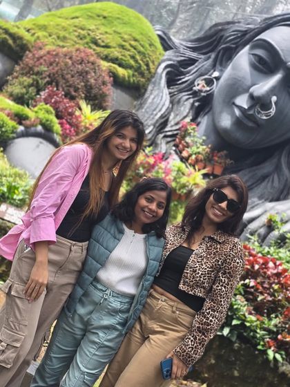 Friends posing at the Adiyogi statue in Chikmagalur. Our trips are full of picture-perfect moments and new profile pictures.