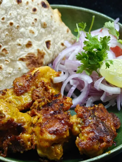 This Chicken Tikka with a beautiful char might cause serious cravings. Served with roti and pickled onions, it's a simple, quick, and delicious meal.