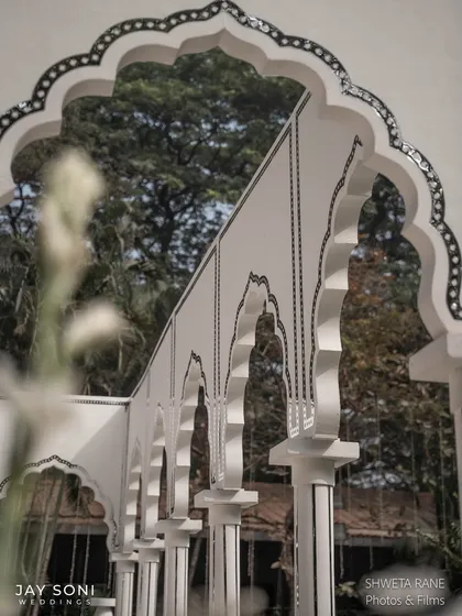 A detail shot of the intricate black and white inlay work on the arches of the lounge pavilion, showcasing the high level of craftsmanship.