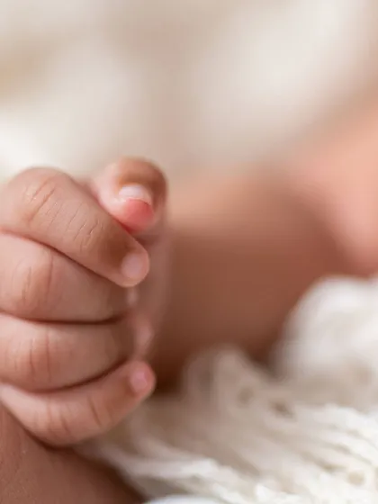 It's the little things that you'll want to remember forever. This close-up shot focuses on the delicate, tiny fingers of a newborn, capturing the fleeting details that make this time so precious. We believe these macro detail shots are an essential part of any newborn gallery.