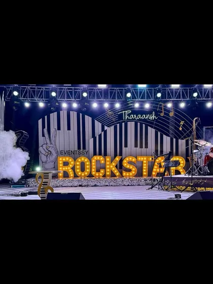 This Rockstar concert party featured a full stage setup with professional lighting trusses, giant piano key backdrops, and marquee letters to make the birthday boy feel like a true star.