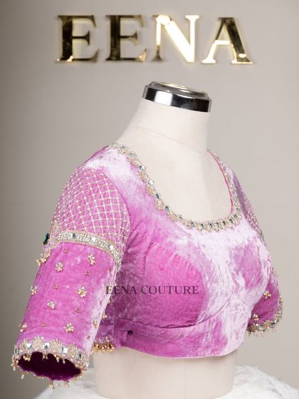 I love blending contemporary design with timeless fabrics. This lavender velvet blouse features a modern jewelry-like embellishment on the sleeves, with a mix of lattice work, pearls, and a central emerald-green stone.