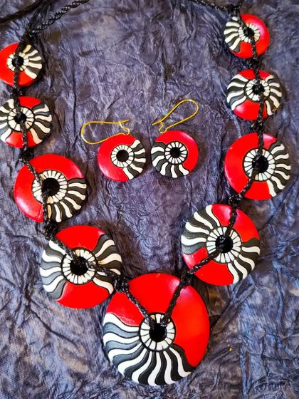 A stylish and modern terracotta set with a unique black, white, and red pattern. The design is abstract and eye-catching, perfect for making a fashion statement.