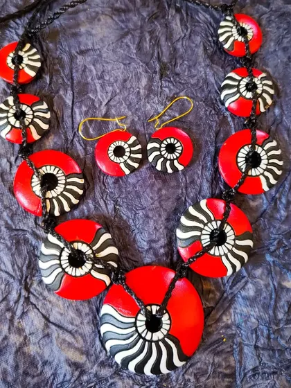 A stylish and modern terracotta set with a unique black, white, and red pattern. The design is abstract and eye-catching, perfect for making a fashion statement.