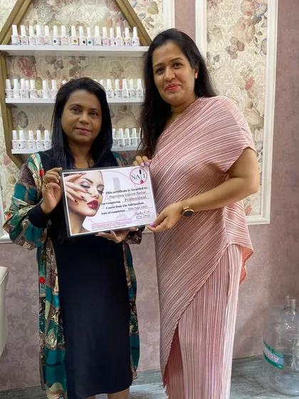 A proud graduate holding her certificate. She has completed the professional course and is ready for the industry.