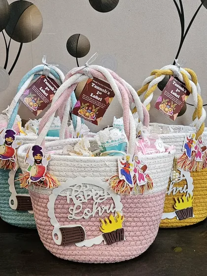 A closer look at the Lohri hamper baskets with "Tanush's 1st Lohri" tags.