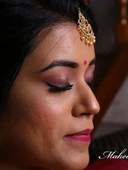 A complete look at Nirosha's engagement style. She wore a vibrant silk saree, and we created a soft glam look with a pretty pink lip and a chic updo.