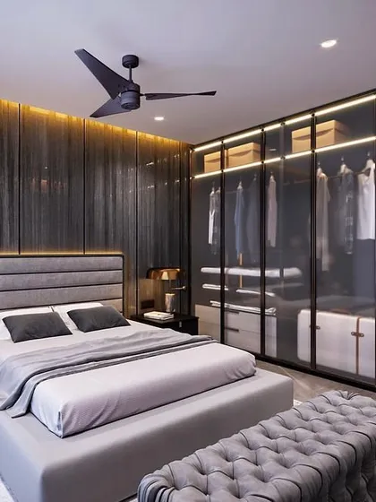 For this master bedroom, the client wanted a dark and moody yet sophisticated vibe. I used a palette of deep greys, a fluted wood accent wall with integrated backlighting, and a glass wardrobe to create a space that feels both dramatic and serene.