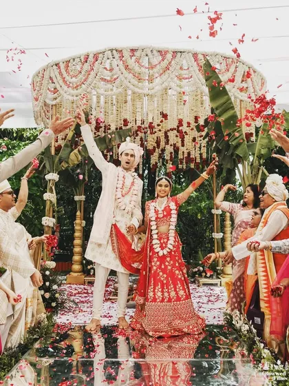 A moment of pure joy as the newlyweds are showered with petals. This South Indian wedding mandap features a beautiful canopy of jasmine and tuberose, blending tradition with a fresh, natural aesthetic.