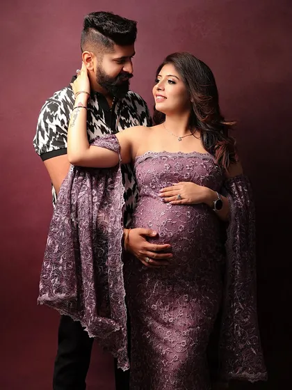 A stylish couple's portrait against a rich, warm backdrop. The way they look at each other tells a beautiful story.