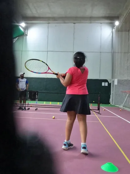 Watching the ball and preparing the backswing. This little champ is learning the basics of a solid groundstroke during a session at our indoor facility.
