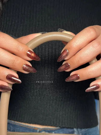 A full look at these sparkly brown cat eye nails. The almond shape and deep, glittery color make this a perfect set for autumn or a glam night out.