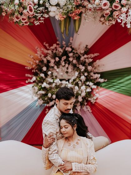 A sweet, quiet moment amidst the colorful chaos of a carnival-themed Sangeet.