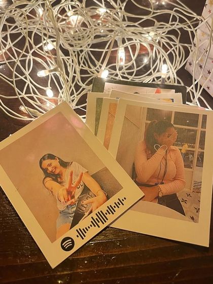 A collection of Spotify polaroid prints ready to be included in a gift hamper.