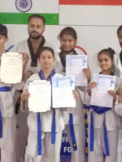 A group of our students proudly displaying their promotion certificates.