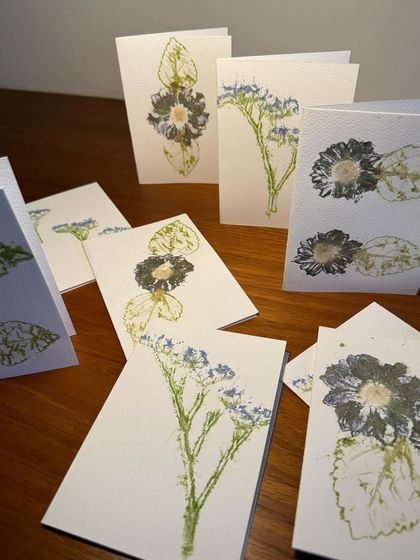 A flat lay of several different greeting card designs. This shows the diversity of patterns and colours that can be achieved through the flower pounding technique.