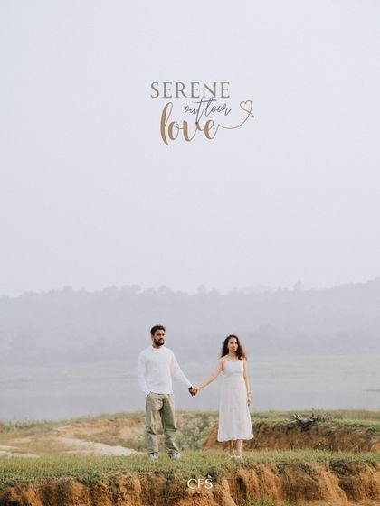 A wide shot showcasing a couple hand-in-hand against a serene, misty landscape. This minimalist composition highlights the feeling of having the whole world to yourselves.