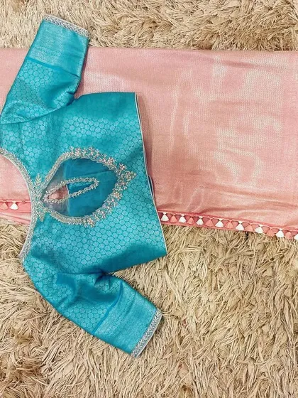 A Hawaiian ocean blue brocade blouse with a cherry blossom pink silk saree, a fresh and modern color pairing.