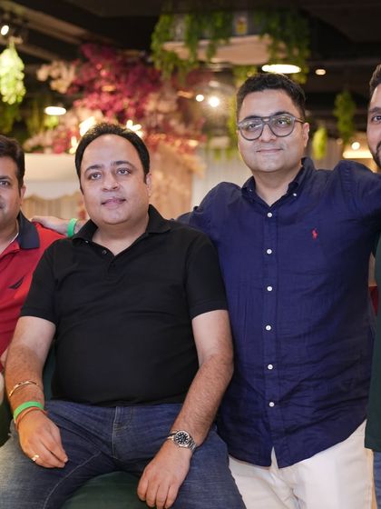 A group of fathers relaxing and enjoying the party. We've created a space where parents can genuinely unwind and have a good time.