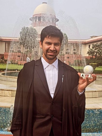 Holding a memento for my performance in the SCAORA T20 Cricket League. This represents a memorable achievement outside the courtroom.