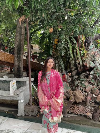A candid moment in my floral suit, surrounded by lush greenery. The outfit and the setting create a serene, spiritual mood.