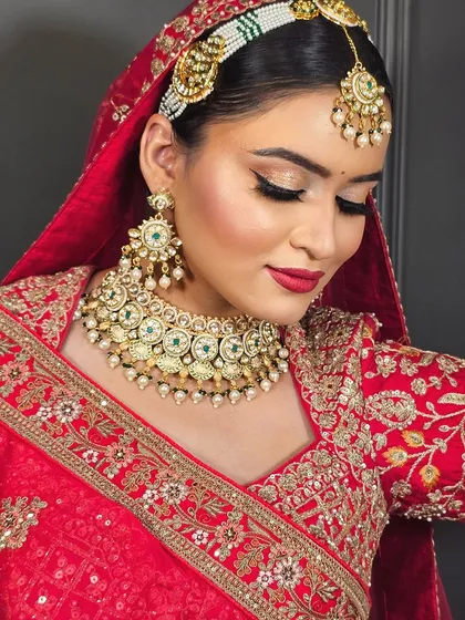 A close-up of a bride with a classic red lip and winged eyeliner. This timeless look is a staple in my bridal makeup course.