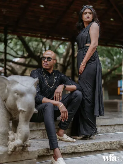 A modern, stylish pose on the stone steps, flanked by our elephant statues. It shows how you can blend contemporary style with the venue's timeless heritage.