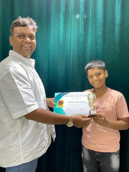 Rasesh Chourasiya proudly holds his certificate and trophy for completing the 2nd level of our abacus program.