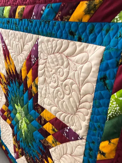 A detail shot of the custom feather quilting in the border.