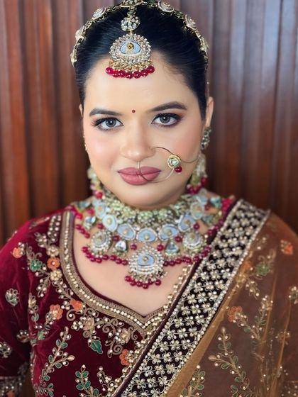 A close-up of the makeup. The smokey eye and matte nude lip create a modern and sophisticated look.