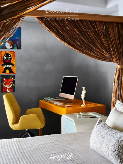A dedicated study corner in the master bedroom features a striking yellow desk and chair from Roche Bobois. The pop of color adds energy to the space, and the wall art was created by the client's talented nephew.